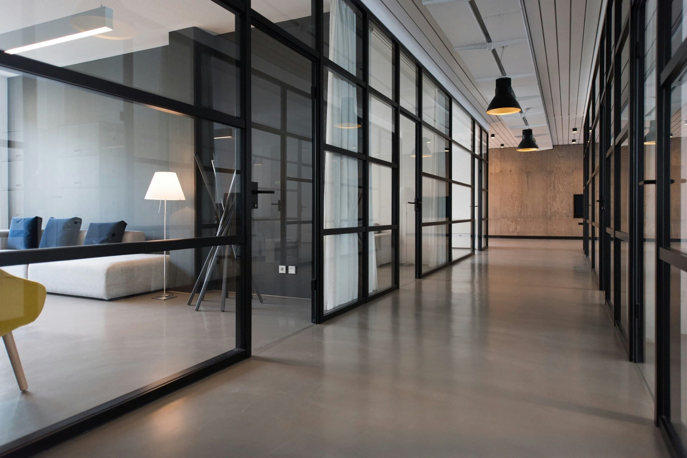 Modern institutional office interior with high ceilings and structural columns